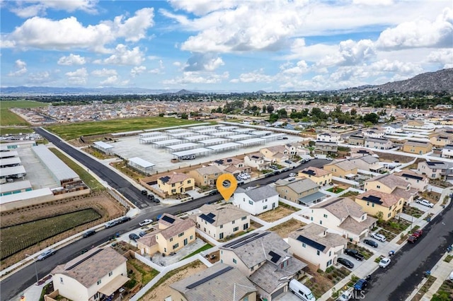 drone / aerial view featuring a residential view and a mountain view