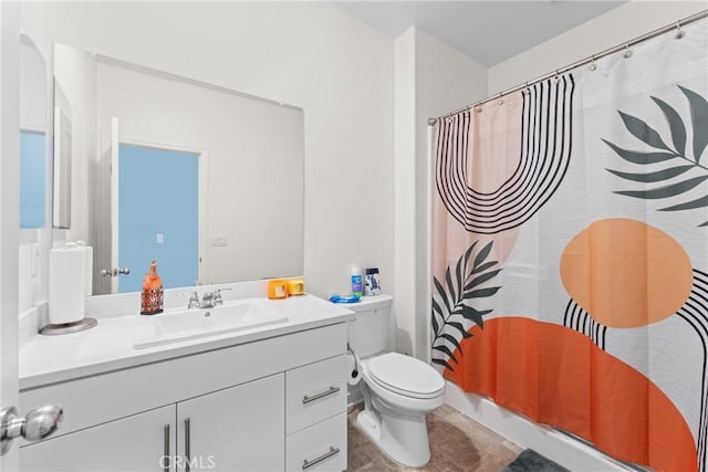 bathroom featuring vanity, tile patterned flooring, toilet, and curtained shower