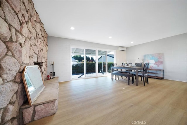 14816 Lanning Dr, Whittier, CA 90604 - dining room with light wood finished floors, a wall mounted AC, a fireplace, and recessed lighting