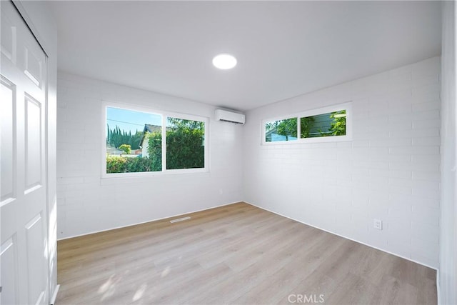 14816 Lanning Dr, Whittier, CA 90604 - unfurnished room featuring a wall mounted air conditioner and light wood-style flooring