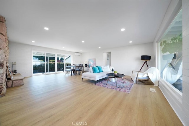 14816 Lanning Dr, Whittier, CA 90604 - living room with light wood-style floors, an AC wall unit, and recessed lighting