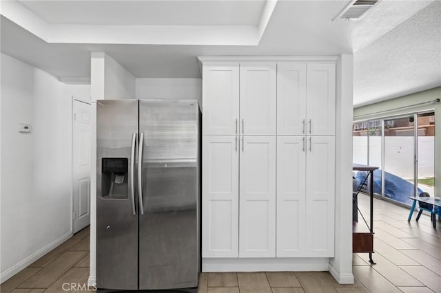 13138 Pan Am Blvd, Moreno Valley, CA 92553 - kitchen featuring stainless steel fridge, white cabinetry, baseboards, and light tile patterned floors