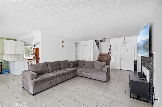 13138 Pan Am Blvd, Moreno Valley, CA 92553 - living room featuring stairs, a textured ceiling, and light tile patterned flooring