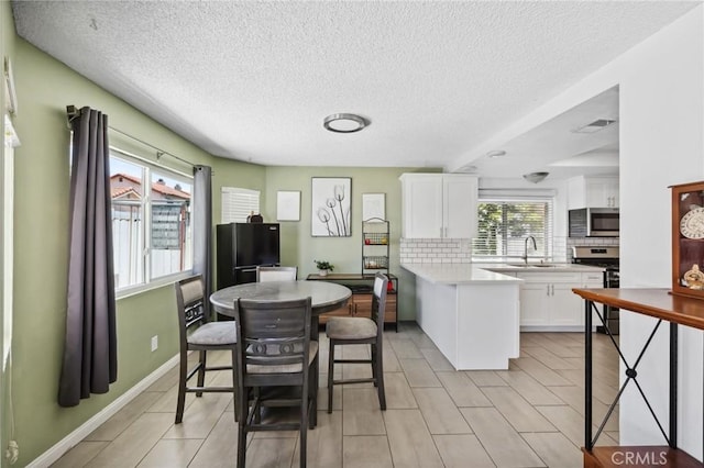 13138 Pan Am Blvd, Moreno Valley, CA 92553 - dining space featuring a textured ceiling and baseboards