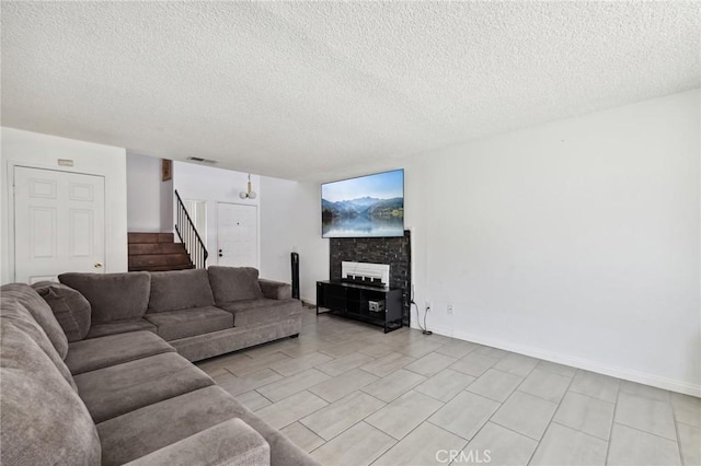 13138 Pan Am Blvd, Moreno Valley, CA 92553 - living room with a textured ceiling, stairway, baseboards, and a fireplace