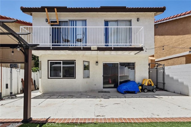 13138 Pan Am Blvd, Moreno Valley, CA 92553 - rear view of property featuring a balcony, stucco siding, and a patio