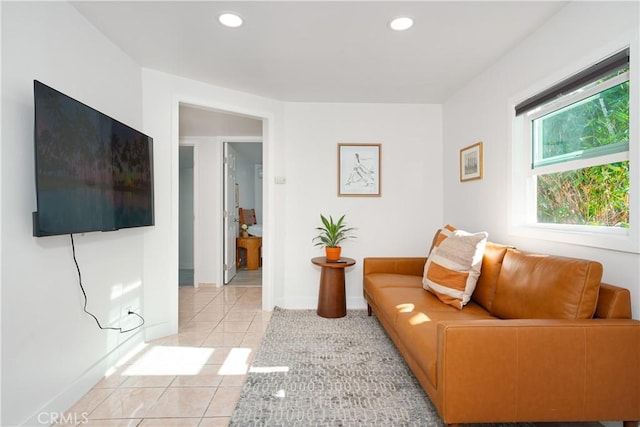 living area featuring baseboards, recessed lighting, and light tile patterned floors