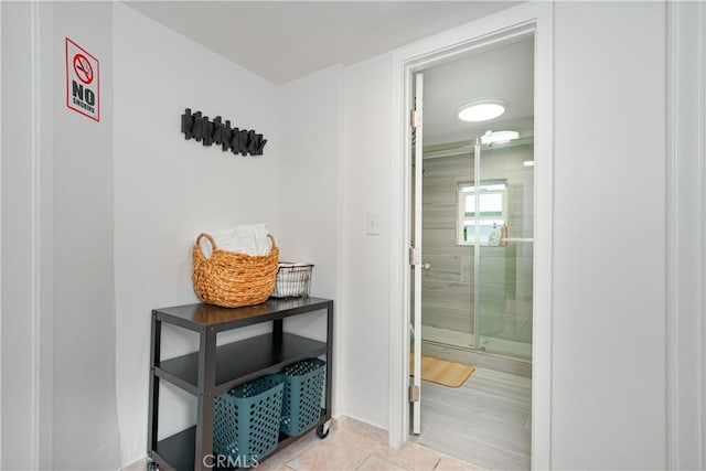 interior space featuring a shower stall and tile patterned floors