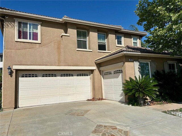 38728 Falkirk Dr, Murrieta, CA 92563 - view of front of house with an attached garage, stucco siding, and concrete driveway