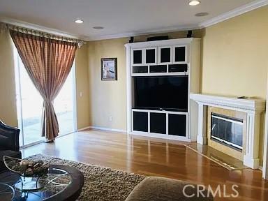 38728 Falkirk Dr, Murrieta, CA 92563 - living area featuring wood finished floors, crown molding, a high end fireplace, baseboards, and recessed lighting