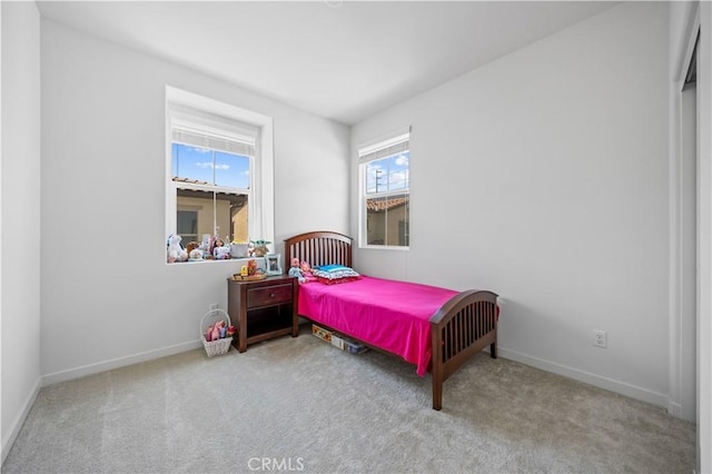 carpeted bedroom featuring baseboards