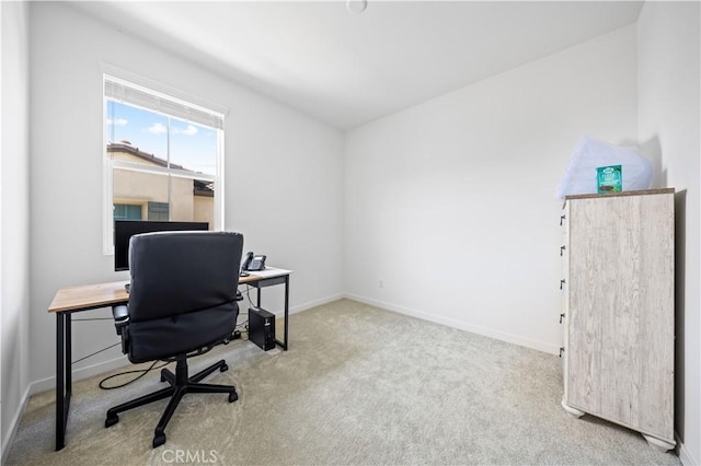 carpeted home office with baseboards