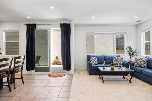tiled living room with recessed lighting, visible vents, and baseboards