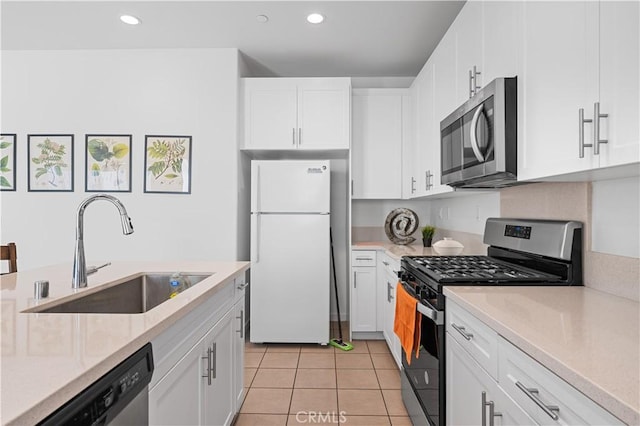 kitchen with white cabinets, a sink, and appliances with stainless steel finishes