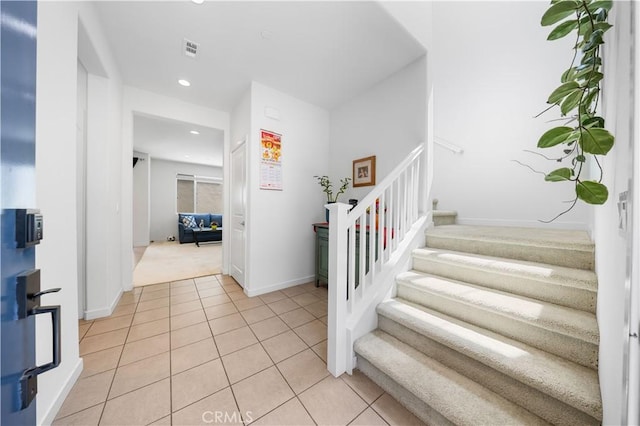 stairs with recessed lighting, carpet, tile patterned flooring, visible vents, and baseboards