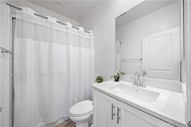 bathroom featuring vanity, a shower with shower curtain, and toilet