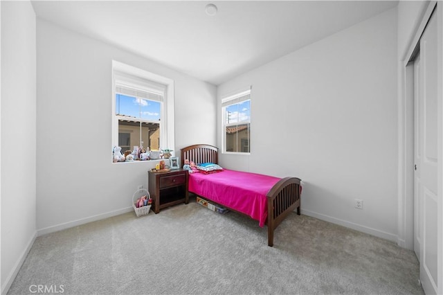 bedroom with carpet flooring and baseboards