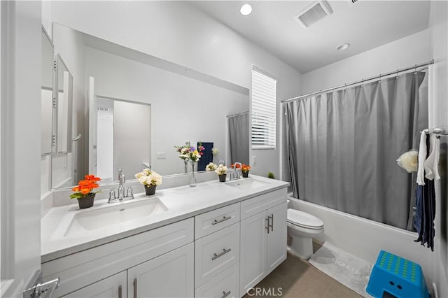 bathroom featuring shower / bathtub combination with curtain, visible vents, toilet, and a sink