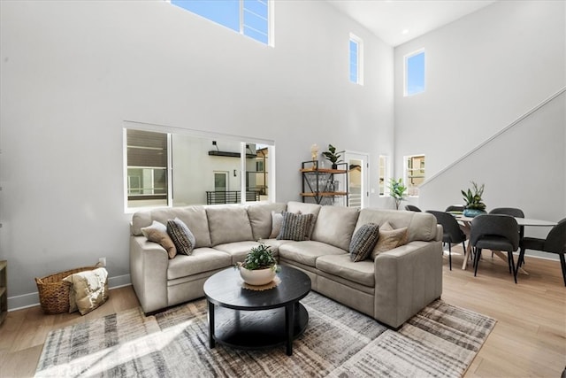 2902 Foundry Ct, Redondo Beach, CA 90278 - living area with light wood-style floors, a healthy amount of sunlight, and a towering ceiling