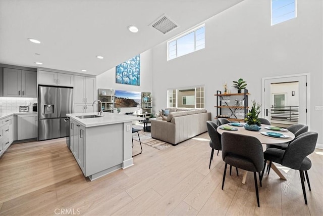 2902 Foundry Ct, Redondo Beach, CA 90278 - kitchen featuring a towering ceiling, visible vents, light countertops, a sink, and stainless steel fridge