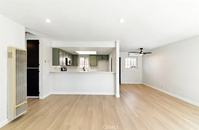 49537 Rosella Dr, Morongo Valley, CA 92256 - unfurnished living room with a heating unit, ceiling fan, light wood finished floors, and baseboards