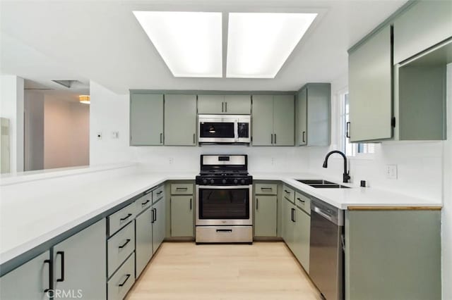 49537 Rosella Dr, Morongo Valley, CA 92256 - kitchen featuring light wood finished floors, a sink, stainless steel appliances, tasteful backsplash, and light countertops