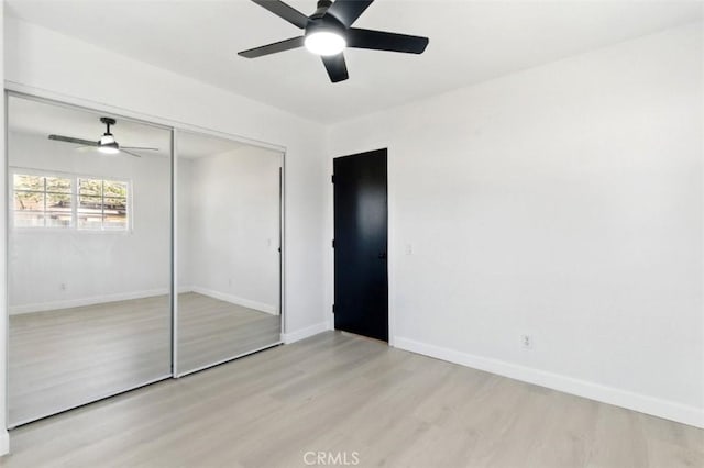 49537 Rosella Dr, Morongo Valley, CA 92256 - unfurnished bedroom featuring baseboards, wood finished floors, ceiling fan, and a closet