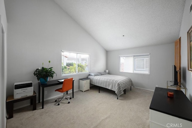bedroom with light carpet, baseboards, a textured ceiling, high vaulted ceiling, and a desk