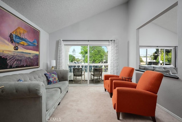 living room featuring light colored carpet, healthy amount of natural light, a textured ceiling, and high vaulted ceiling