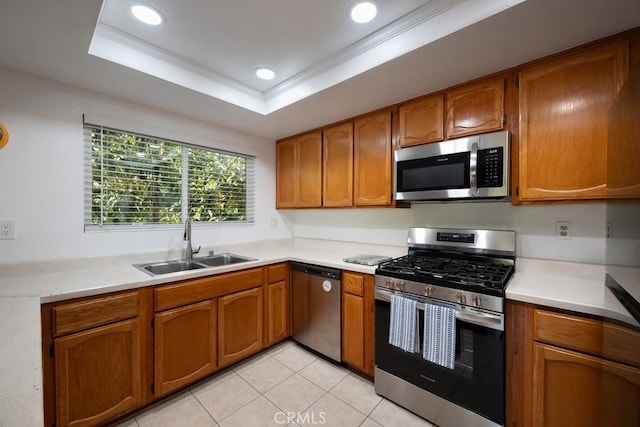 kitchen with appliances with stainless steel finishes, a sink, brown cabinets, light countertops, and recessed lighting