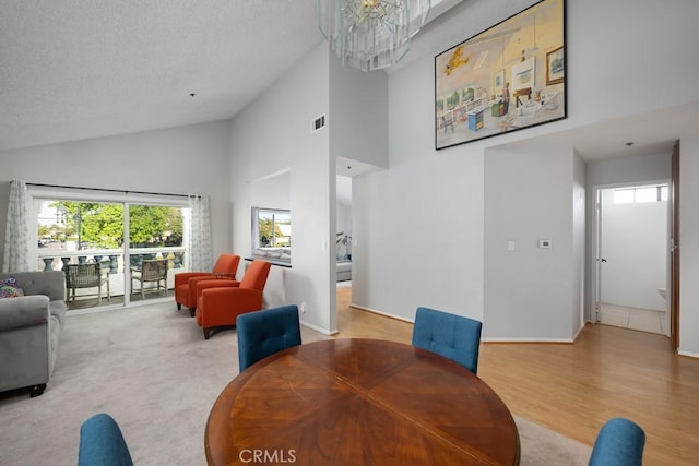 5624 Orange Ave, Cypress, CA 90630 - dining space featuring high vaulted ceiling, a chandelier, baseboards, and light wood-style flooring