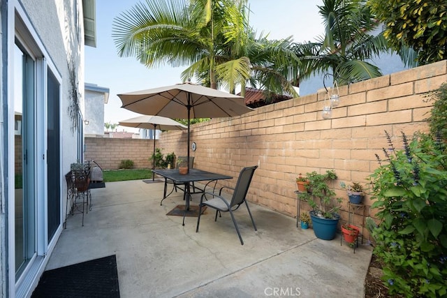 view of patio / terrace featuring outdoor dining space and a fenced backyard