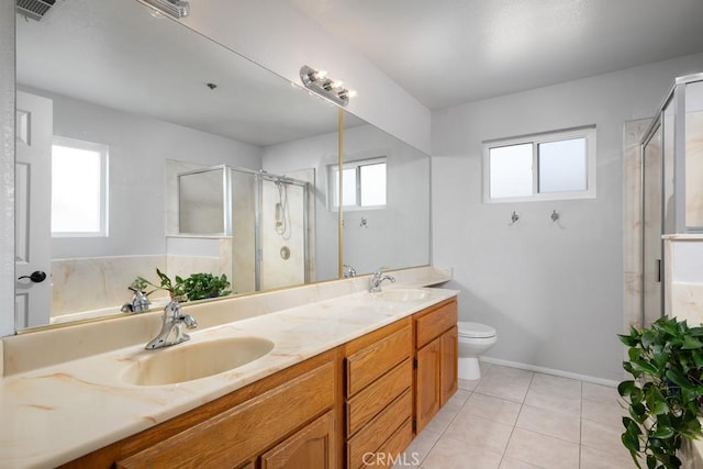 bathroom with a stall shower, tile patterned flooring, double vanity, toilet, and baseboards
