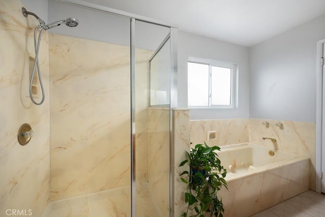 bathroom with a marble finish shower and a bath