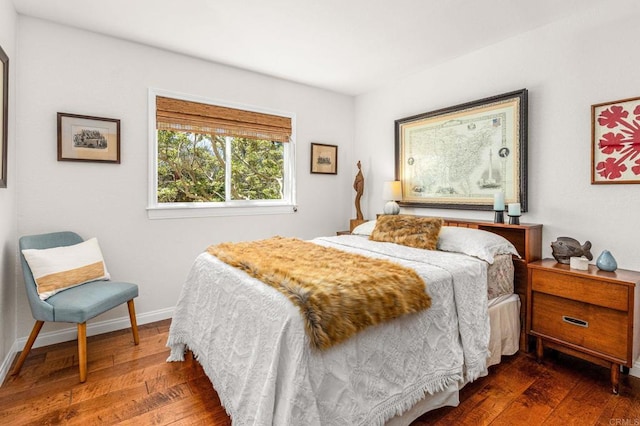 bedroom with wood-type flooring and baseboards