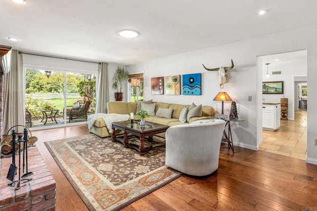 living area with light wood-type flooring, baseboards, recessed lighting, and visible vents