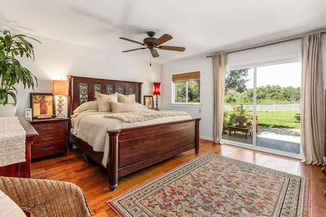 bedroom with wood-type flooring, access to exterior, and a ceiling fan