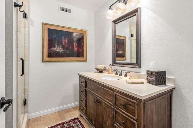 bathroom with baseboards, vanity, and visible vents
