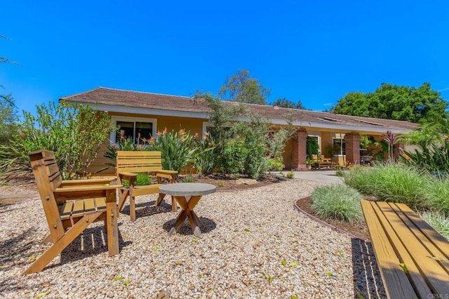 back of property with a patio