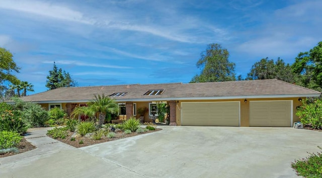ranch-style home featuring driveway and a garage