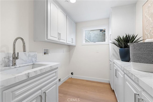 105A Surfside Ave, Surfside, CA 90743 - washroom with hookup for a washing machine, cabinet space, and light wood-style floors