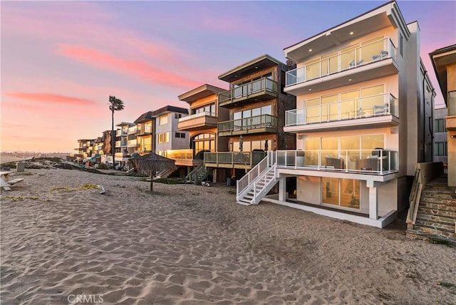 105A Surfside Ave, Surfside, CA 90743 - back of property at dusk with stairs and stucco siding