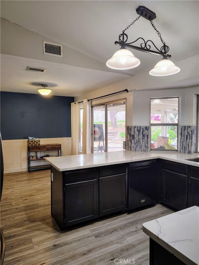 14055 Camino Del Oro, Riverside, CA 92508 - kitchen featuring black dishwasher, a peninsula, a wainscoted wall, lofted ceiling, and dark cabinets