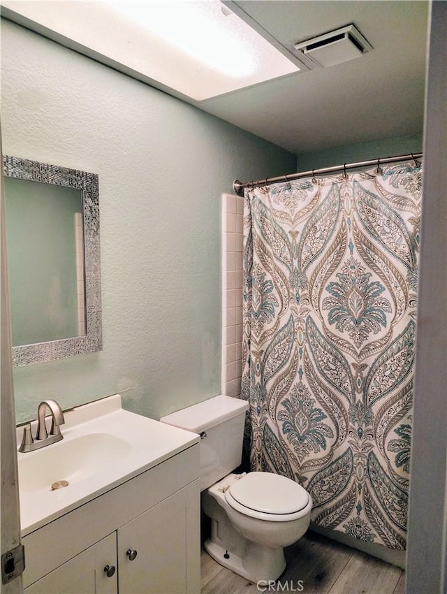 14055 Camino Del Oro, Riverside, CA 92508 - bathroom featuring vanity, toilet, wood finished floors, a textured wall, and a shower with curtain