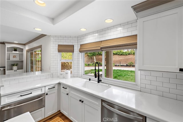 28166 Camellia Ct, Laguna Niguel, CA 92677 - kitchen with stainless steel dishwasher, a warming drawer, a sink, tasteful backsplash, and light countertops