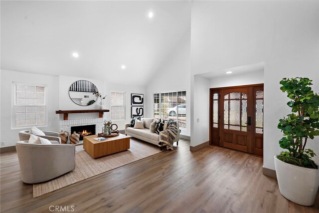 28166 Camellia Ct, Laguna Niguel, CA 92677 - living room with a fireplace, high vaulted ceiling, wood finished floors, and recessed lighting