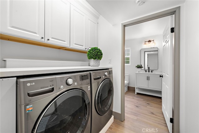 28166 Camellia Ct, Laguna Niguel, CA 92677 - washroom with cabinet space, washing machine and clothes dryer, light wood-type flooring, and baseboards