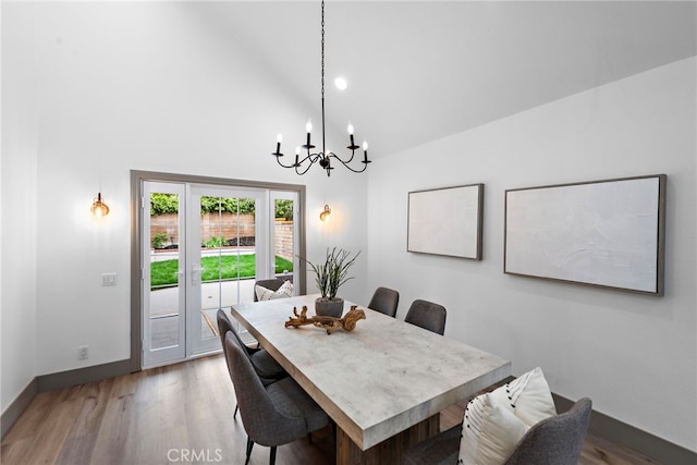 28166 Camellia Ct, Laguna Niguel, CA 92677 - dining space featuring a chandelier, baseboards, wood finished floors, and high vaulted ceiling