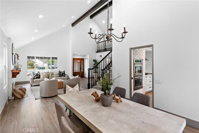 28166 Camellia Ct, Laguna Niguel, CA 92677 - dining room featuring high vaulted ceiling, light wood-style flooring, a chandelier, stairway, and beamed ceiling
