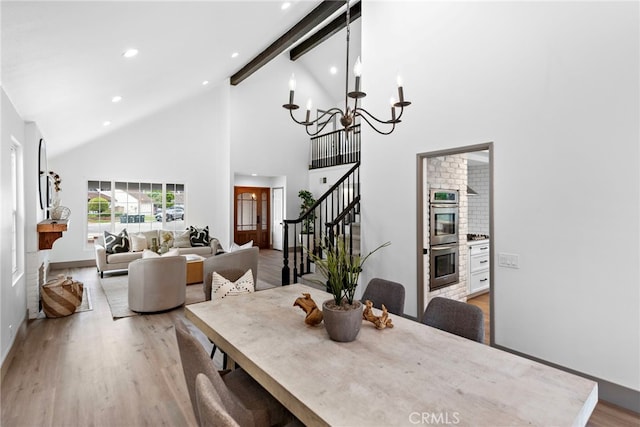 28166 Camellia Ct, Laguna Niguel, CA 92677 - dining room featuring high vaulted ceiling, light wood-style flooring, a chandelier, stairway, and beam ceiling